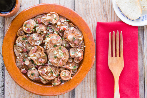 Saffron milk cap mushrooms on a clay pot photo