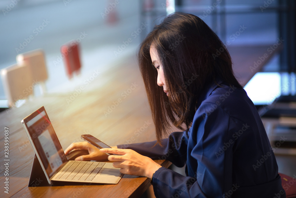 Young asian business woman working online on laptop and smartphone. Modern lifestyle Young asian business woman working online on laptop and smartphone. Modern lifestyle