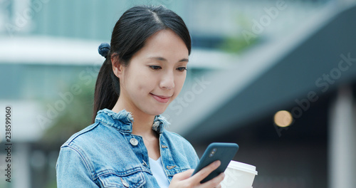 Photography Woman use of smart phone and holding coffee cup