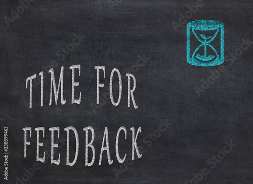 Time for feedback - Hourglass with text on a black background