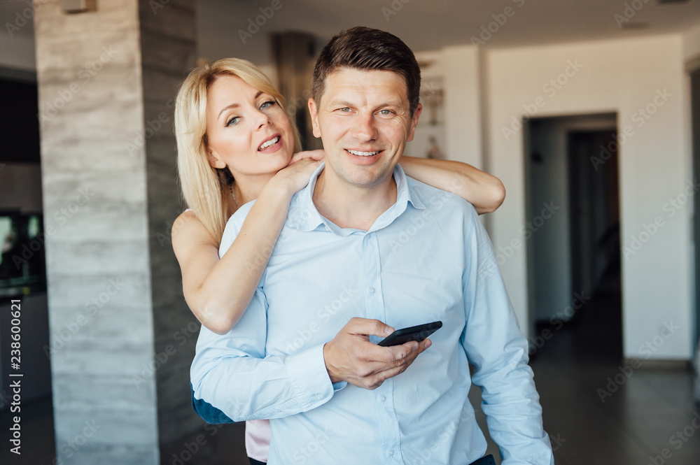 Naklejka premium Jealous woman looking at her partner chatting on the phone
