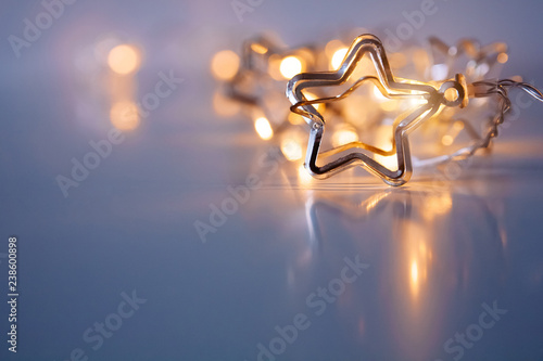 A stars shaped christmass garland on the table. Space for text