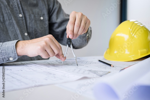 Construction engineering or architect hands working on blueprint inspection in workplace, while checking information drawing and sketching for architecture project working