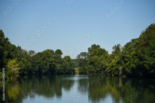 calm river, canal with trees