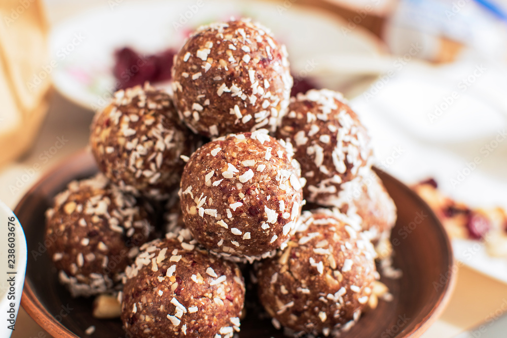 Raw cocoa and coconut energy balls in a clay plate Raw cocoa and coconut energy balls in a clay plate