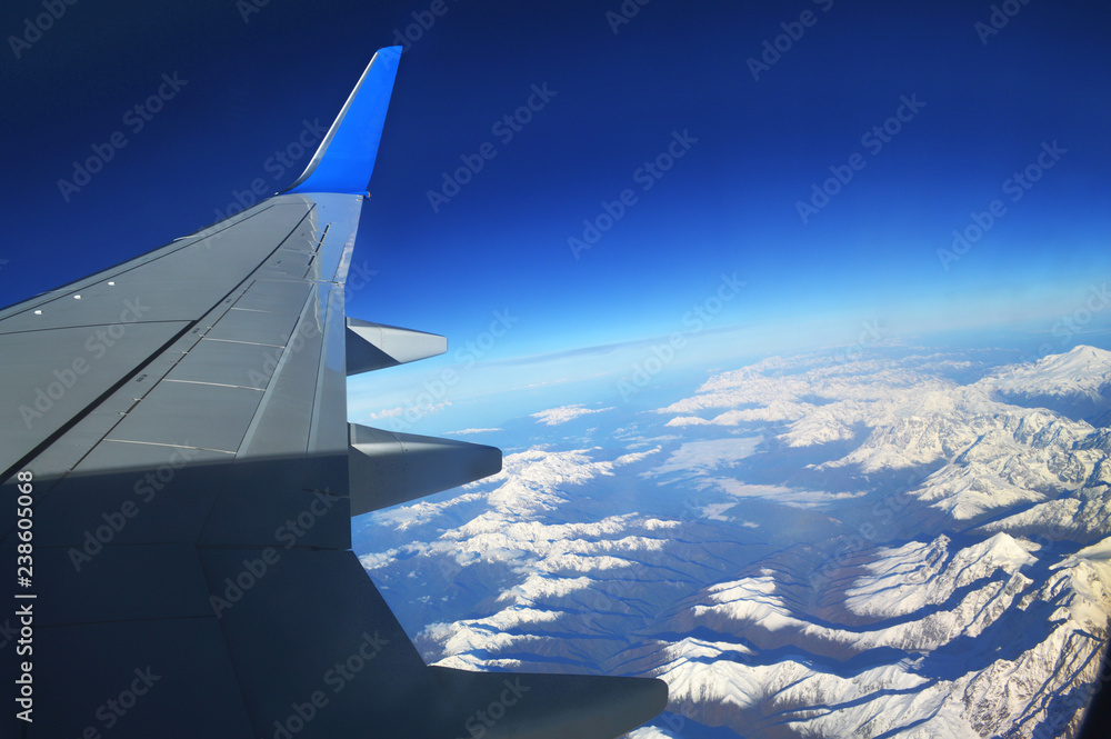 The view from the window of an airplane over the mountains of the Caucasus