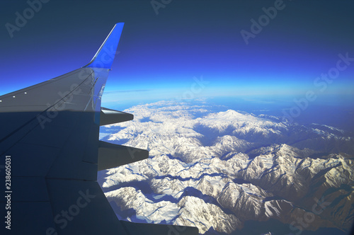 The view from the window of an airplane over the mountains of the Caucasus