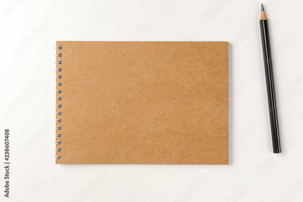Blank notebook with pencil on white background. Workplace. Copy space. Minimal concept. Top view. Flat lay Blank notebook with pencil on white background. Workplace. Copy space. Minimal concept. Top view. Flat lay
