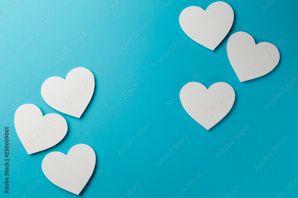 Valentine's Day postcard. Valentine's Day Background. Six valentine's paper hearts on blue background. Copy space. Top view. Flat lay. Pastel colors Valentine's Day postcard. Valentine's Day Background. Six valentine's paper hearts on blue background. Copy space. Top view. Flat lay. Pastel colors
