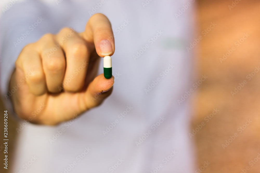 Pharmacist holding a pill 