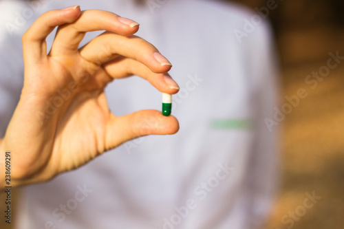 Pharmacist holding a pill 