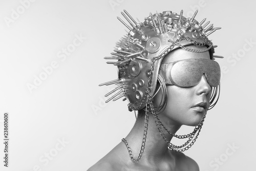 Futuristic woman in metal helmet and glasses