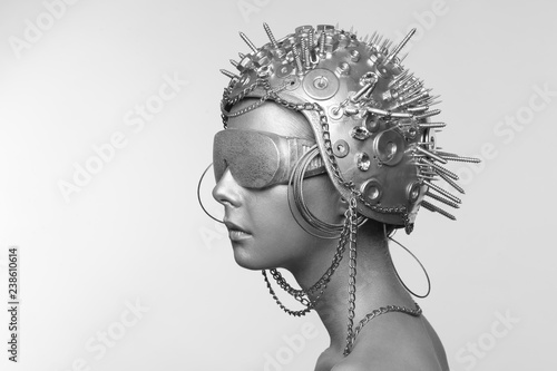 Futuristic woman in metal helmet and glasses photo