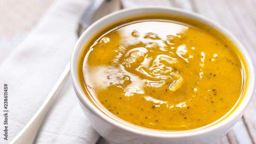 Close of white bowl with cabotia pumpkin soup Close of white bowl with cabotia pumpkin soup
