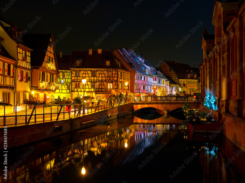Colmar town night lights and reflecions on the water, traditional alsatian houses