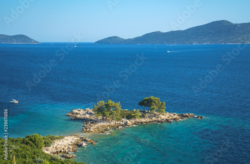 Aerial seascape view to turquoise waters of Adriatic Sea and islands in the distance, near town Dubrovnik in Croatia. Famous sailing travel destination in Croatia, Dubrovnik summer scenery in Europe.