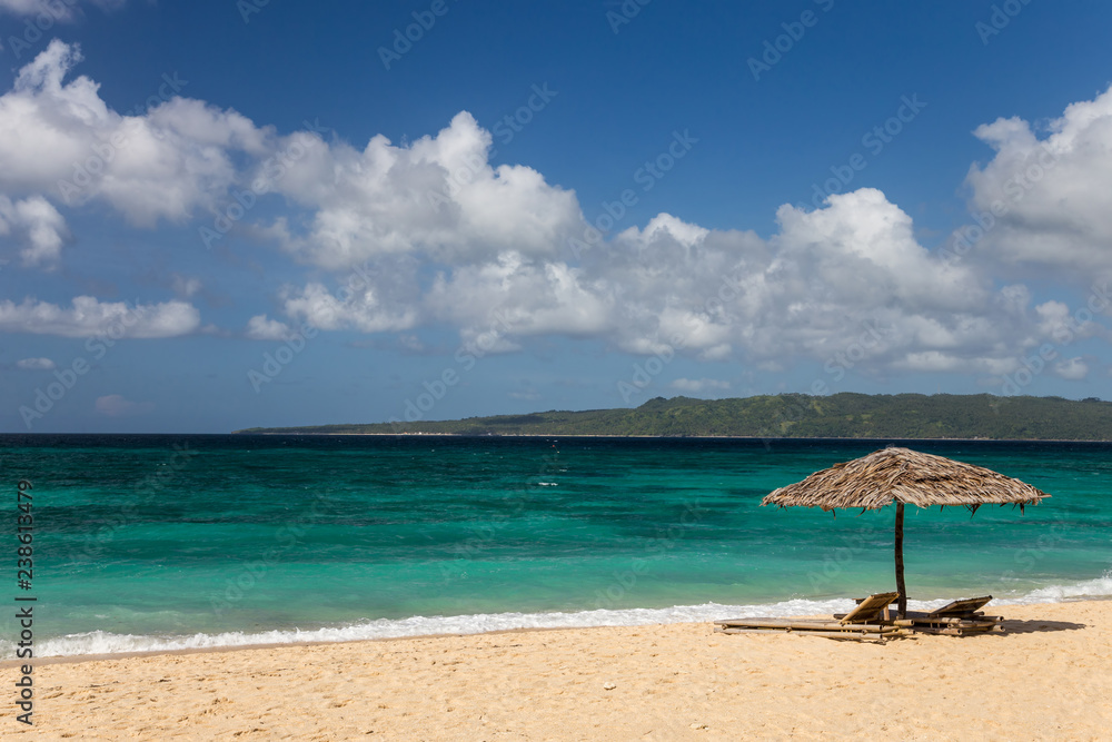 Sunbeds and umbrellas on a white sand beach Sunbeds and umbrellas on a white sand beach