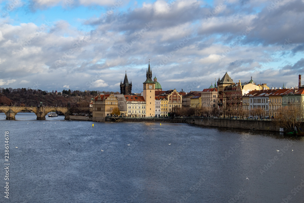 Fototapeta premium Prague, Czech Republic, Europe, panorama overlooking the historic buildings of Prague Castle, Charles Bridge and the Vltava River in front of interesting blue sky with clouds