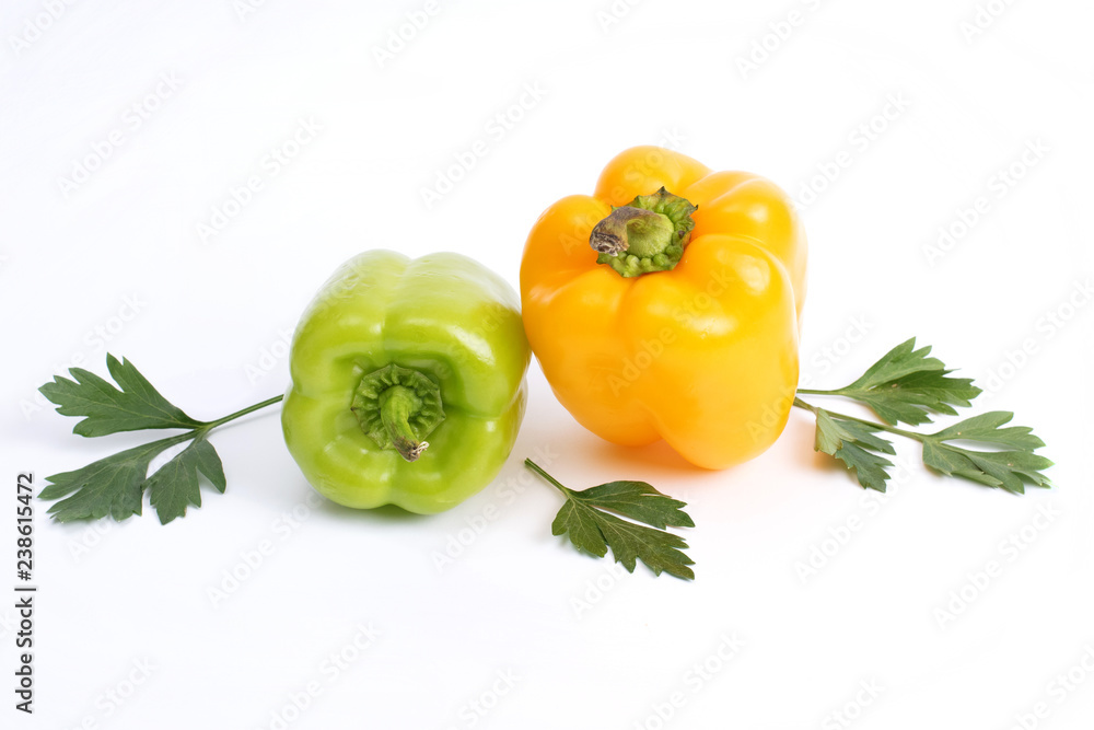 Green and yellow sweet peppers on a white background. Green and yellow sweet peppers on a white background.