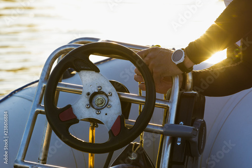 Men's hands on a motor boat