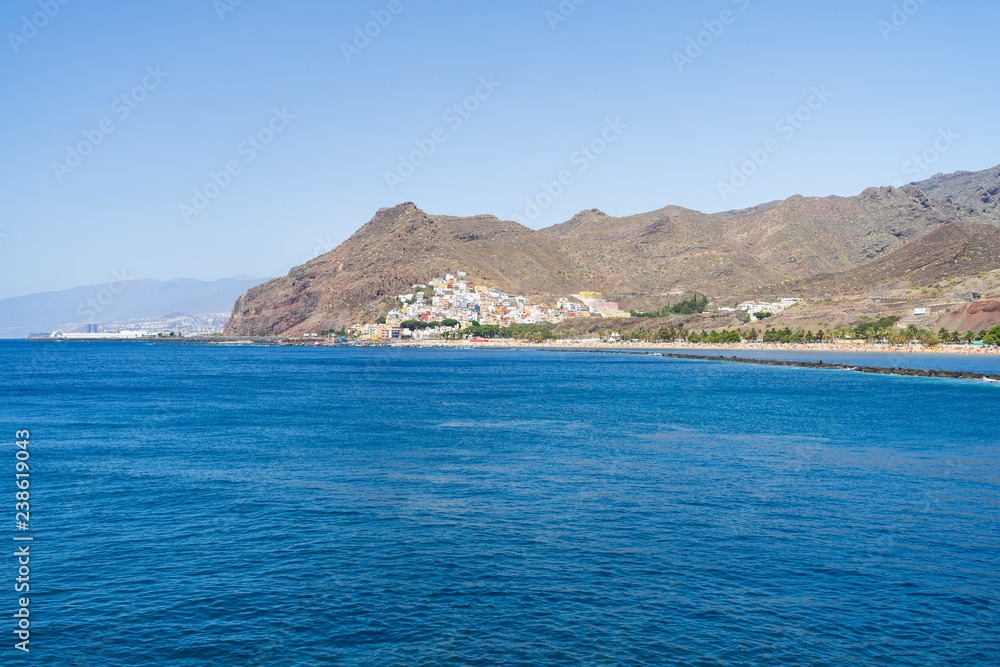View from the Atlantic Ocean on the famous white sand beach Playa de Las Teresitas and the village on the mountainside - San Andres. Tenerife. Canary Islands. Spain.