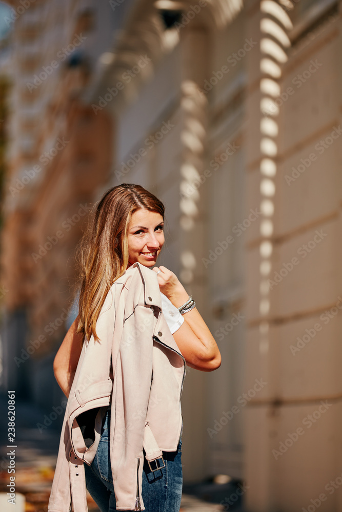 Young attractive woman posing on the street.