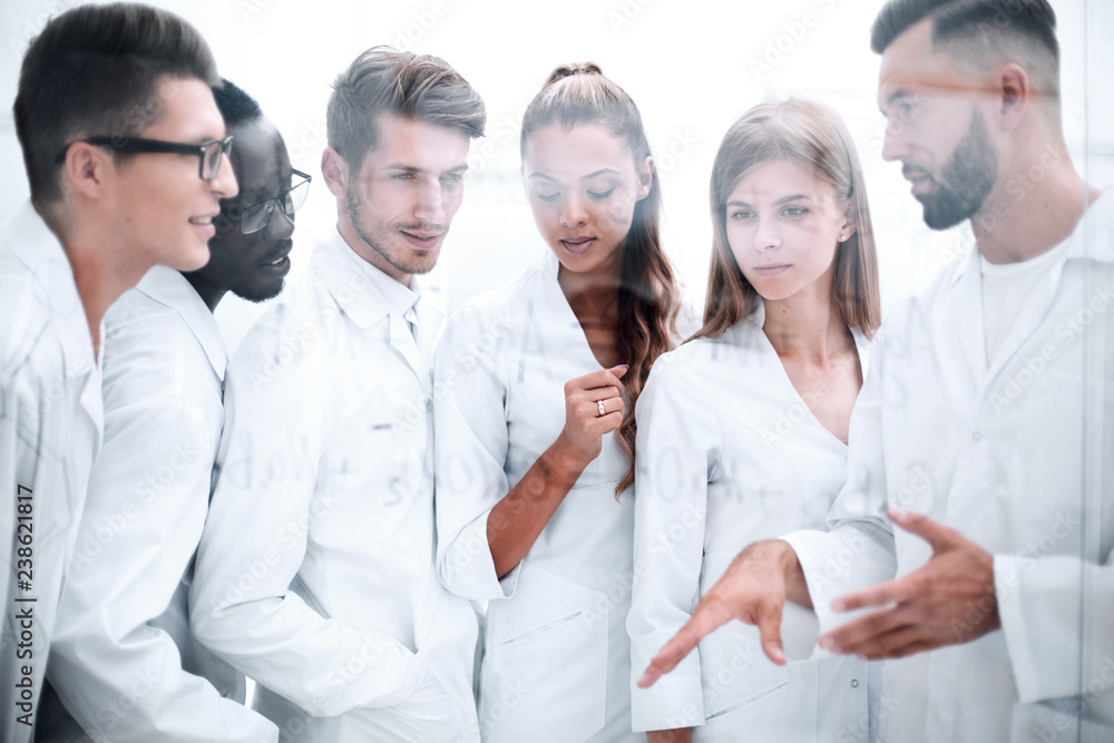 group of scientists discussing chemical formulas