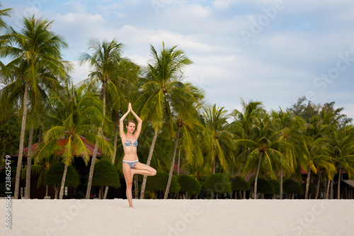 Girl practicing yoga Langkawi island photo