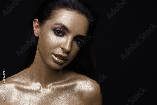 Wallpaper Mural Beauty fashion art model girl with Golden skin make up and body on black background. Gold body art. Metallic, glance beautiful lady face. Border Fashion art portrait, make up, gift  Torontodigital.ca