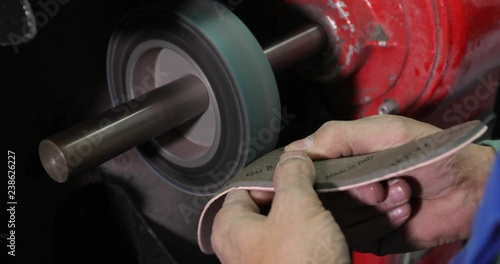 Shoe maker, master, craftsman, workman is manufacture, produce, make oxford style man shoes in a small atelier. 