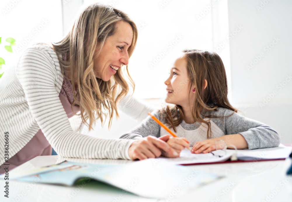 A Mother and Child doing homework at home A Mother and Child doing homework at home