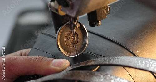 View of sewing machine for shoes. Woman s hand working at the factory with thread. 4K