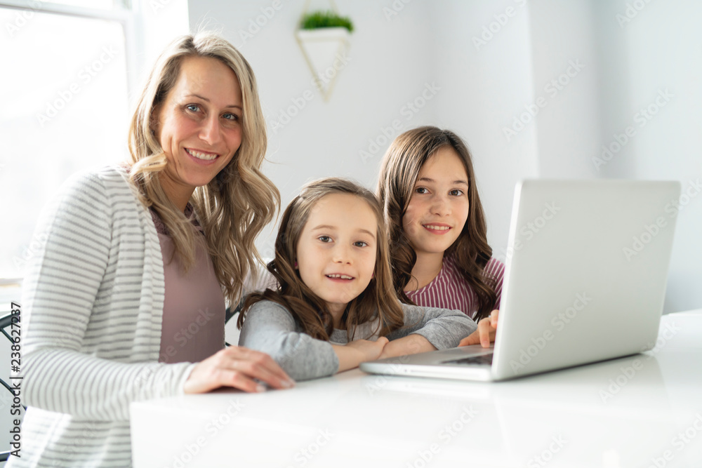 A Nice mom spend time with kids watching educational programs on laptop A Nice mom spend time with kids watching educational programs on laptop