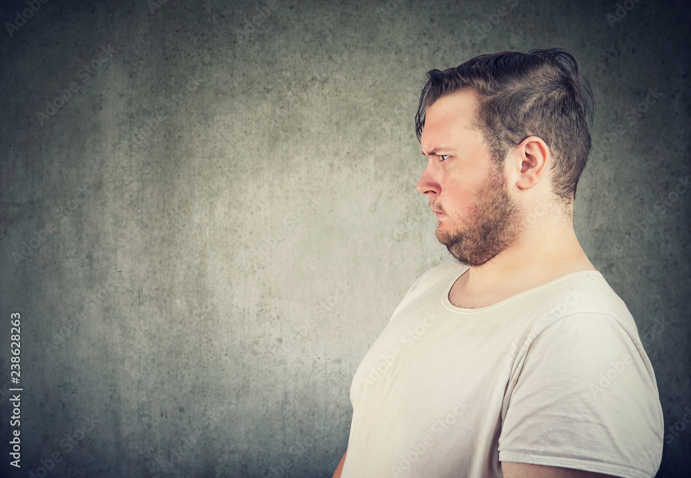 Annoyed chunky man looking away Annoyed chunky man looking away