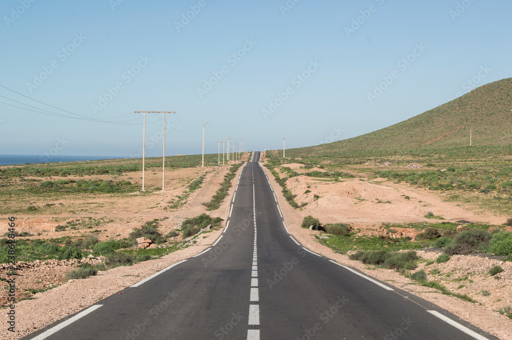 road to nowhere in the middle of semi-desert in Morocco with ocean in the backdround road to nowhere in the middle of semi-desert in Morocco with ocean in the backdround