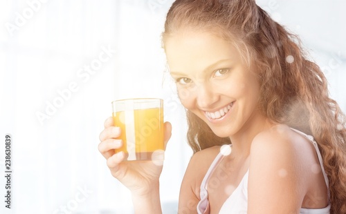 Attracive young woman enjoying tea and fruits on breakfast
