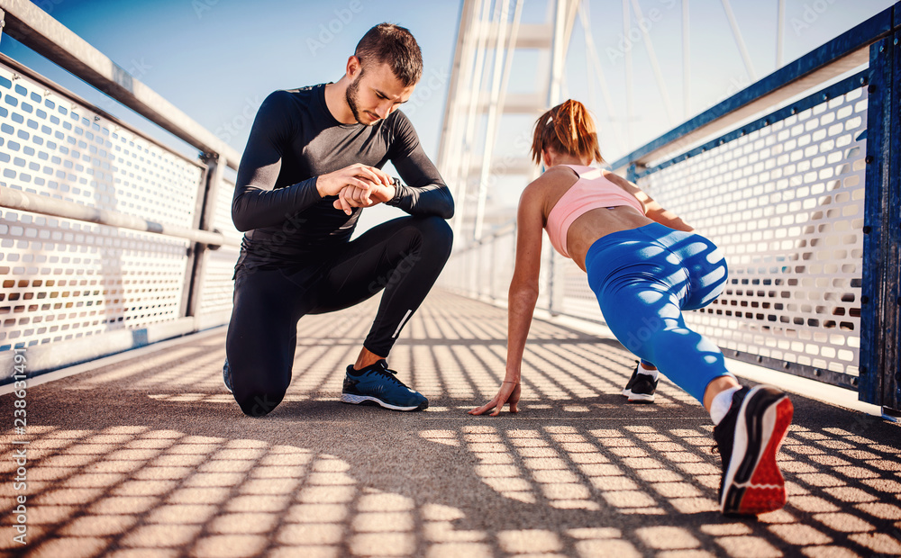 Obraz premium Jogging. Young couple enjoys together in the morning training outdoor. Sport, fitness, recreation concept