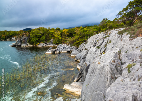 Rugged shores of Lough Leane (lake of learning, the largest of the three lakes of Killarney. County Kerry, Ireland.
