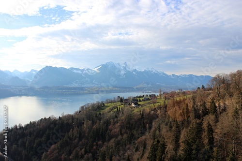 View of the lake, among the snow-capped mountains, in winter. Lake Thun is a lake in the canton of Bern in Switzerland, in the city of Thun. It is a natural lake formed by the river Aare.