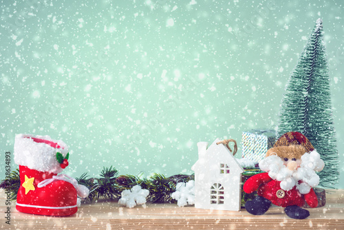 Christmas background. Christmas tree and ornaments lie on a wooden table snowy weather. Space for text. It's snowing. Merry Christmas. New Year's background. Toned image.