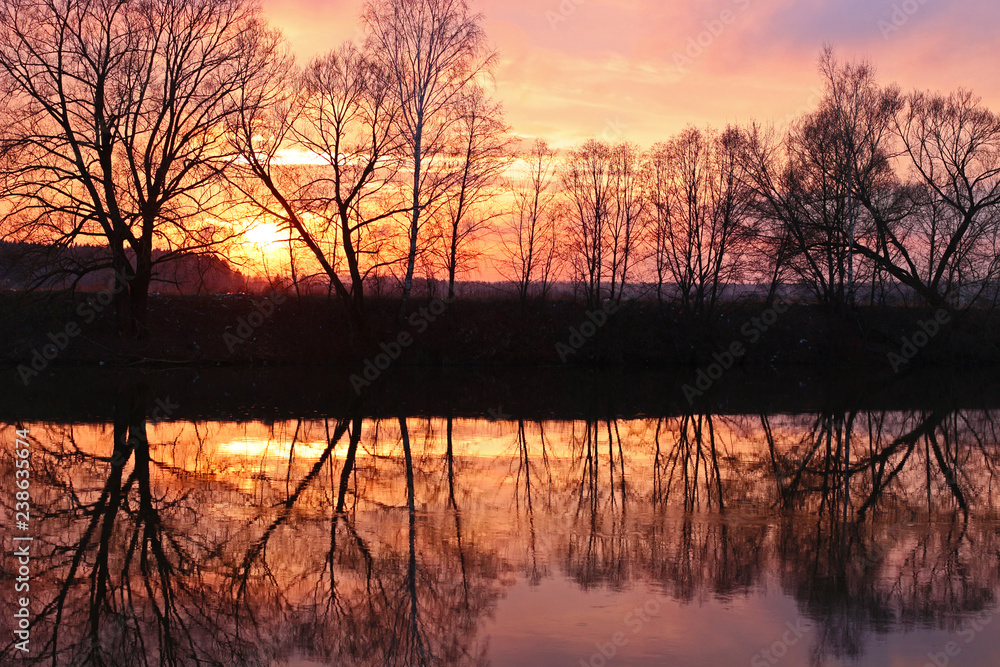 Beautiful lilac-pink sunset over the river in April. River Protva, Russia
Beautiful lilac-pink sunset over the river in April. River Protva, Russia
