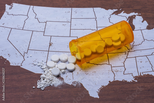 Opioid and drug addiction epidemic concept on USA map with pills and bottle and room for copy text