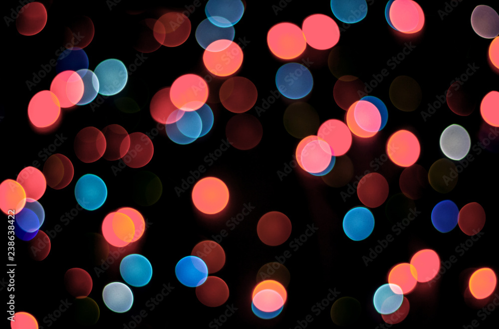 Abstract living coral and blue bokeh texture on black background. Defocused sparkles. Color of the year. Abstract living coral and blue bokeh texture on black background. Defocused sparkles. Color of the year.