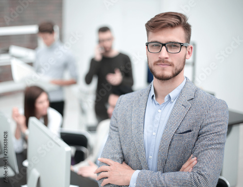 confident young businessman on the background of the office photo