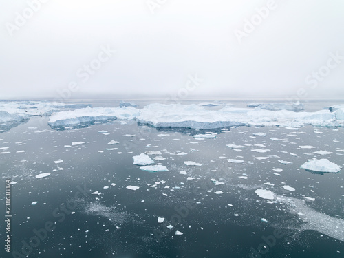 The glaciers are melting on arctic ocean in Greenland. Big glaciers day by day broking and dangerous for world climate system. Shooting day was foggy weather and glaciers didn't look clear. 