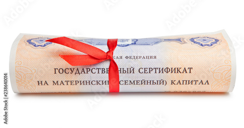 Fotografia State certificate of the Russian Federation maternal family capital, rolled up in a scroll with a red ribbon