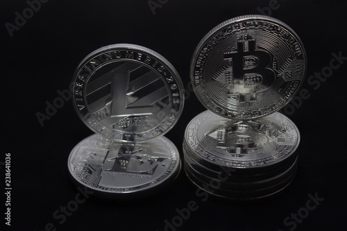 Crypto currencies bitcoin and litecoin on a black background © Jiri