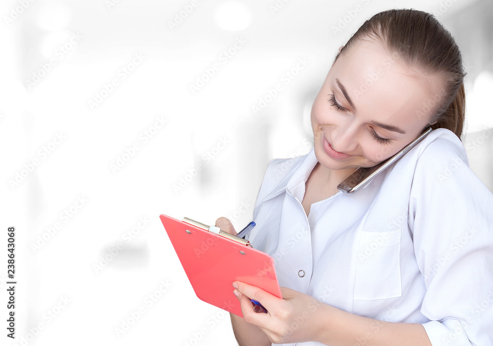 Front view of a young intellectual healthcare doctor in labcoat on black backround. Doctor with a notebook in his hands with free space for text Front view of a young intellectual healthcare doctor in labcoat on black backround. Doctor with a notebook in his hands with free space for text