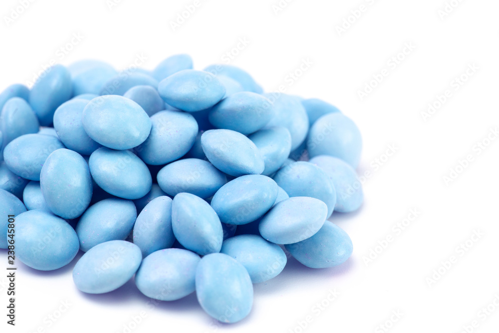 Pile of Blue Candy Coated Chocolate Gems on a White Background Pile of Blue Candy Coated Chocolate Gems on a White Background
