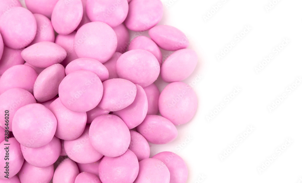 Pile of Pink Candy Coated Chocolate Gems on a White Background
